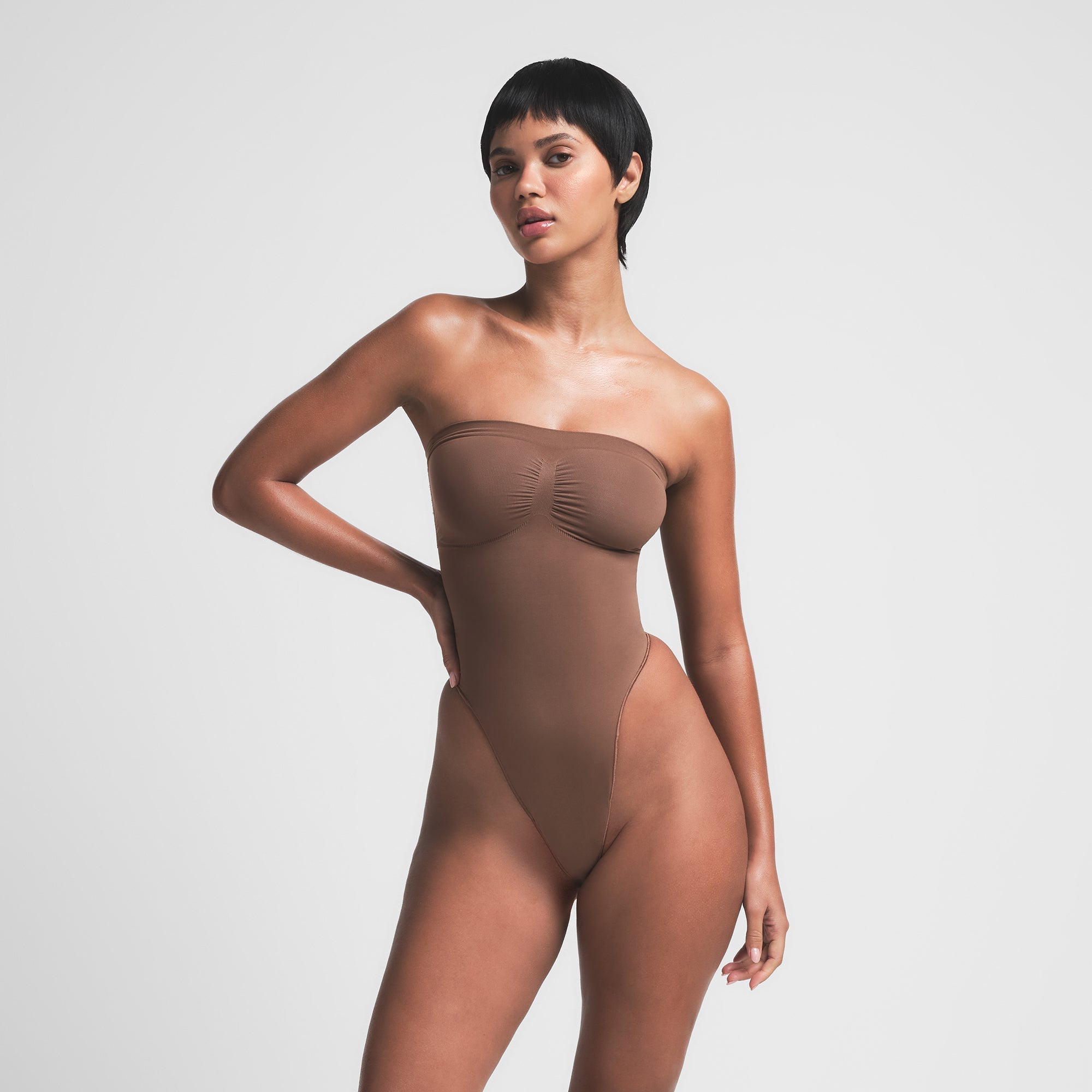 SKIMS SEAMLESS SCULPT STRAPLESS THONG BODYSUIT | JASPER